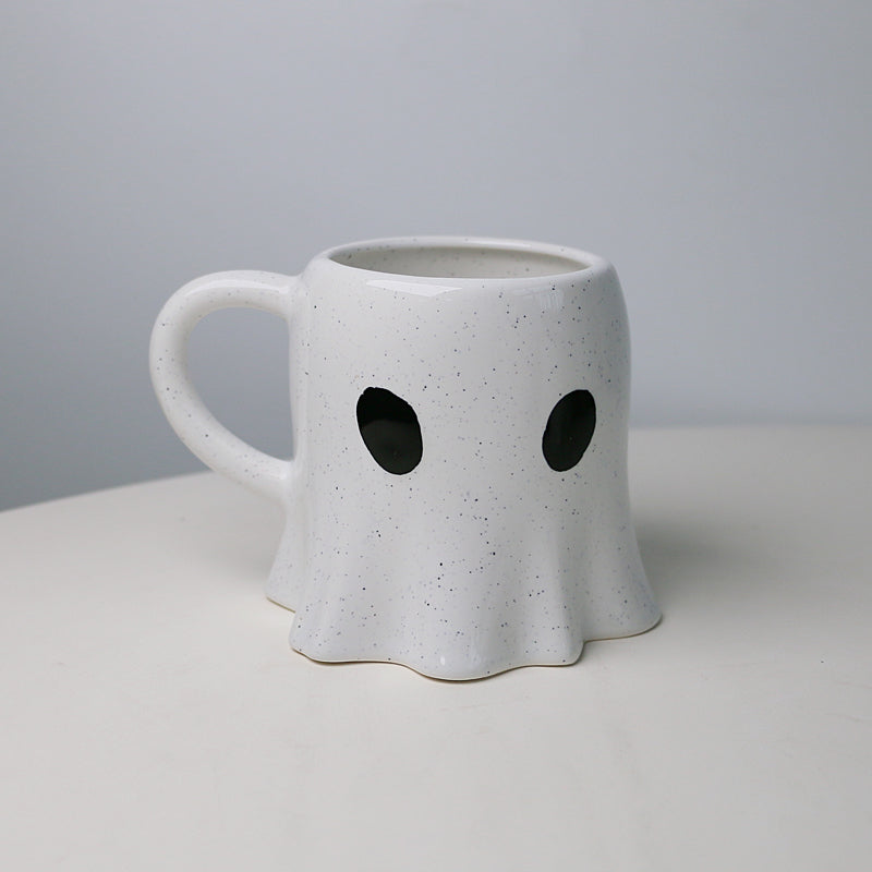 cup in a ghost shape with tiny black eyes