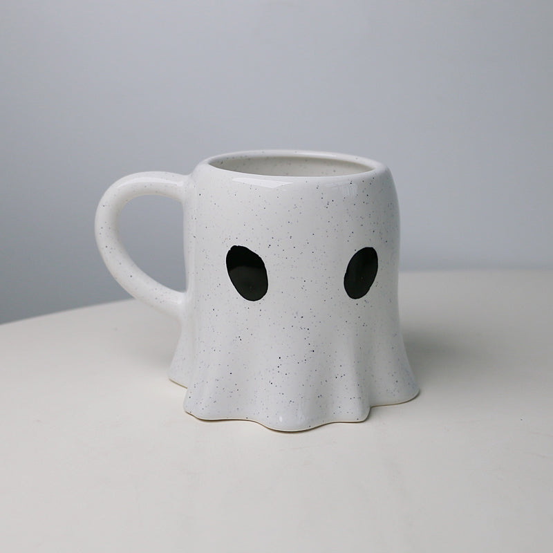 cup in a ghost shape with tiny  black eyes
