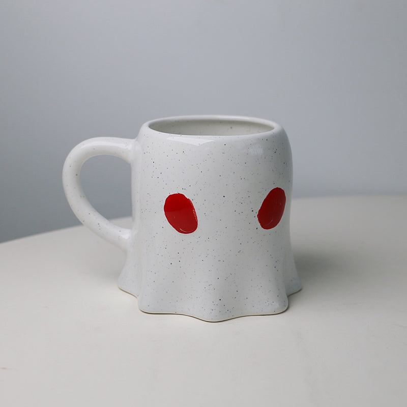 cup in a ghost shape with tiny red eyes